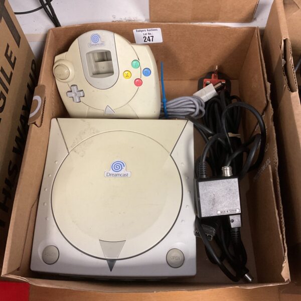 White Sega Dreamcast console with accessories, a classic retro gaming system.