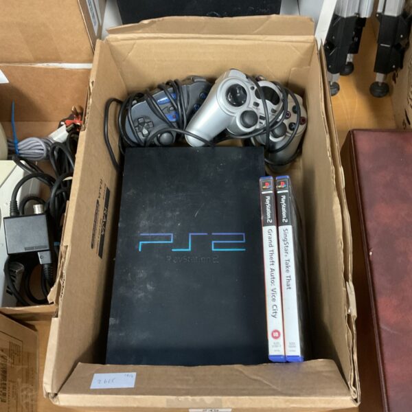 Sony PlayStation 2 console with controllers and games for retro gaming.