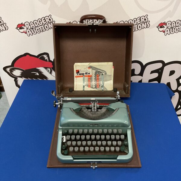 Teal vintage Imperial Good Companion typewriter with open case.