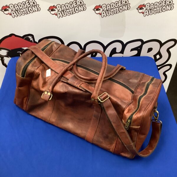 Vintage brown leather holdall, classic travel bag.