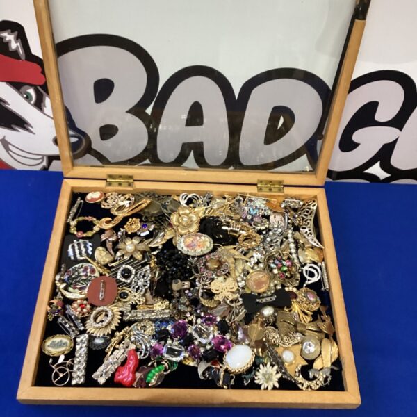 Vintage costume jewellery lot with colourful brooches and pins.