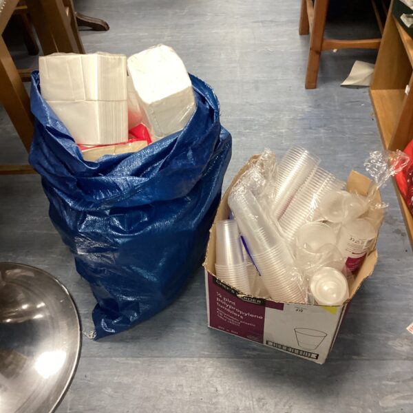 Catering supplies lot with napkins and clear plastic cups.