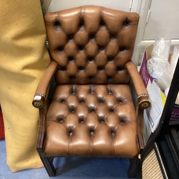 Vintage brown leather chesterfield armchair with button back detail.