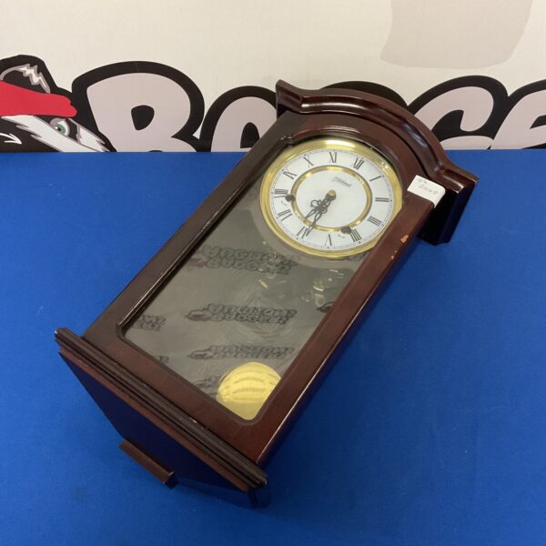 Vintage Highlands wall clock with Roman numerals and wooden case.