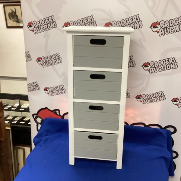 Small white four-drawer unit for bedroom or desk storage.