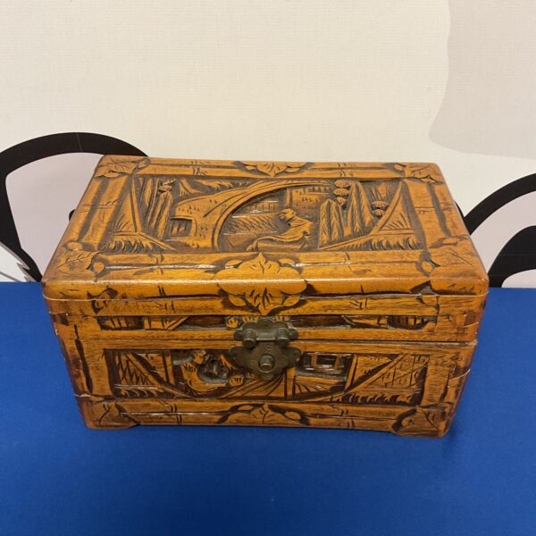 Intricate carvings on a vintage hand-carved wooden box.