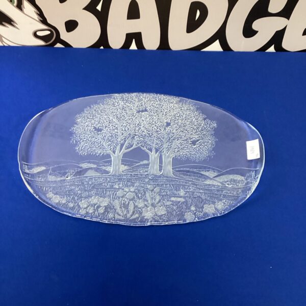 Detailed etched glass tray with landscape design for serving or display.