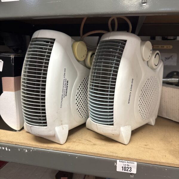 Pair of vintage portable fan heaters for localised heating.