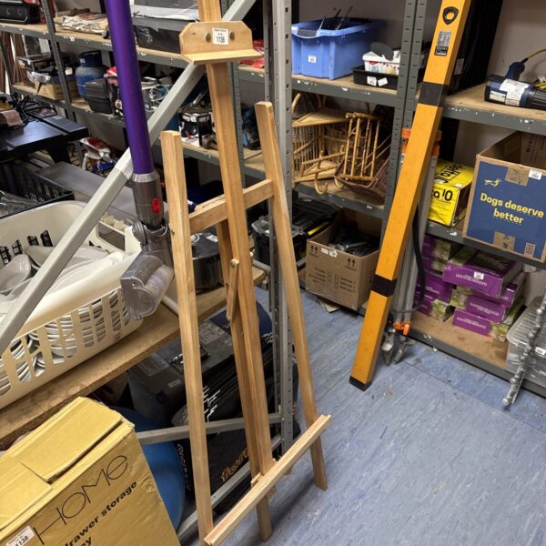 Large wooden artist easel for studio painting and display.