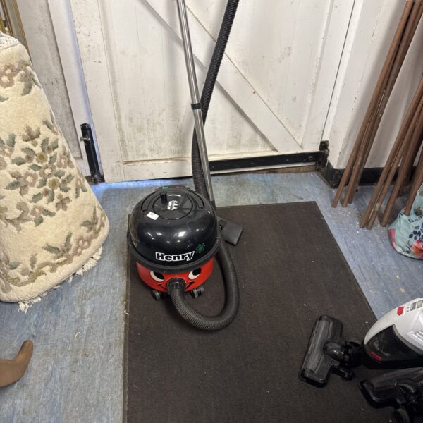 Red Numatic Henry hoover, a classic cylinder vacuum cleaner.