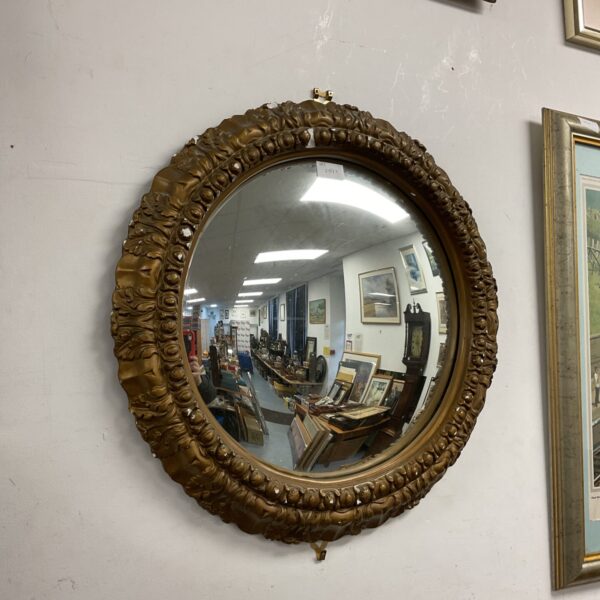 Ornate vintage jesso framed convex mirror for wall décor.