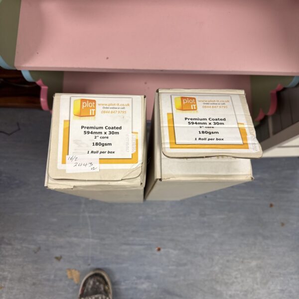 Two rolls of premium coated 594mm paper in packaging.