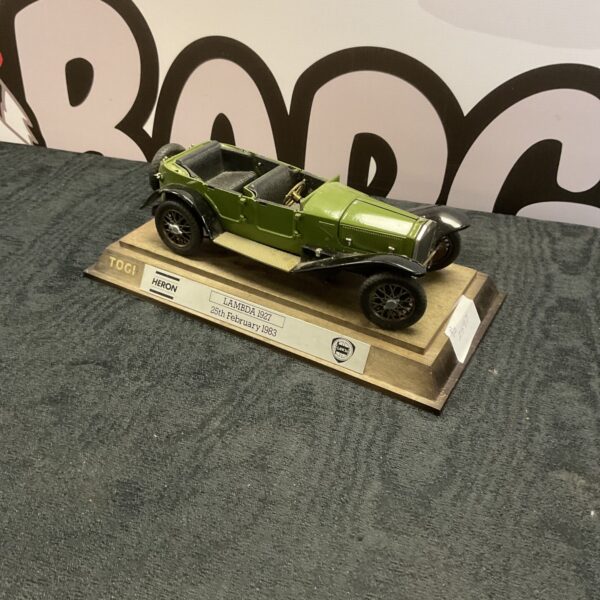 Vintage Togi Heron Lambda 1927 diecast model car on display.