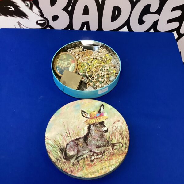 Vintage costume jewellery lot in decorative tin.