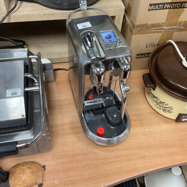 Sleek Sage Nespresso coffee machine for home espresso brewing.