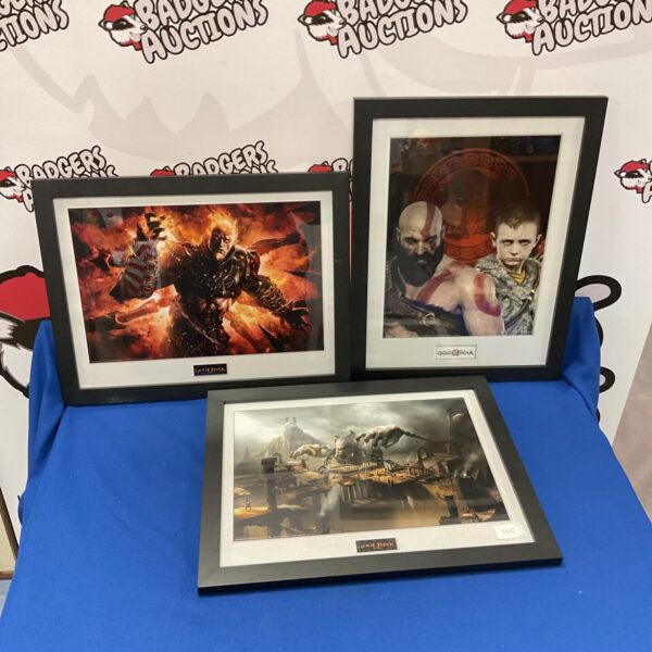 Framed God of War prints featuring Kratos in dynamic poses.