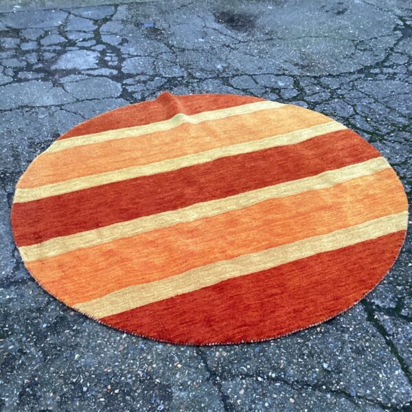 Vibrant orange and red striped rug for home decor.