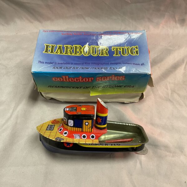 Vintage tin plate harbour tug boat, a collectible nautical toy.
