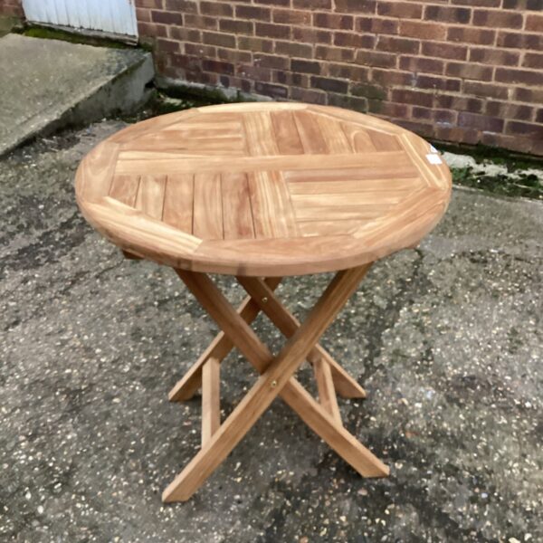 Round wooden folding garden table for outdoor use.