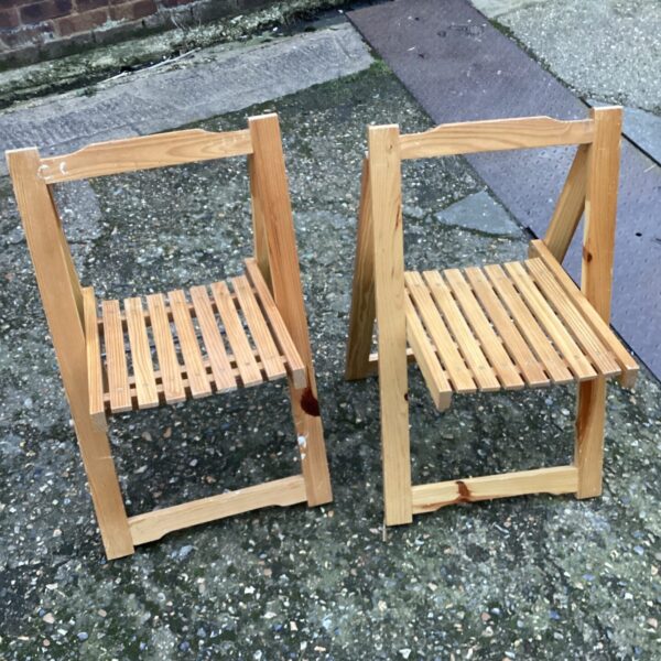 Pair of vintage wooden folding chairs for garden or camping.