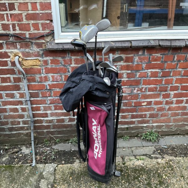 Vintage Wilson golf clubs in a Donnay golf bag, showing wear.