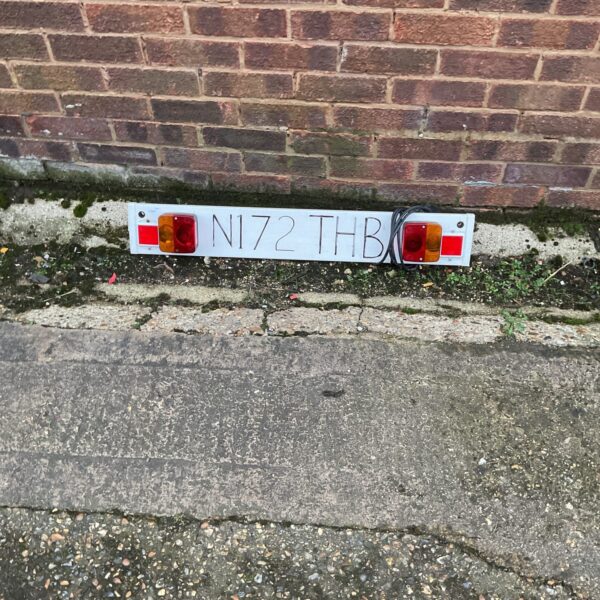 Vintage trailer light board with red tail lights and indicators.