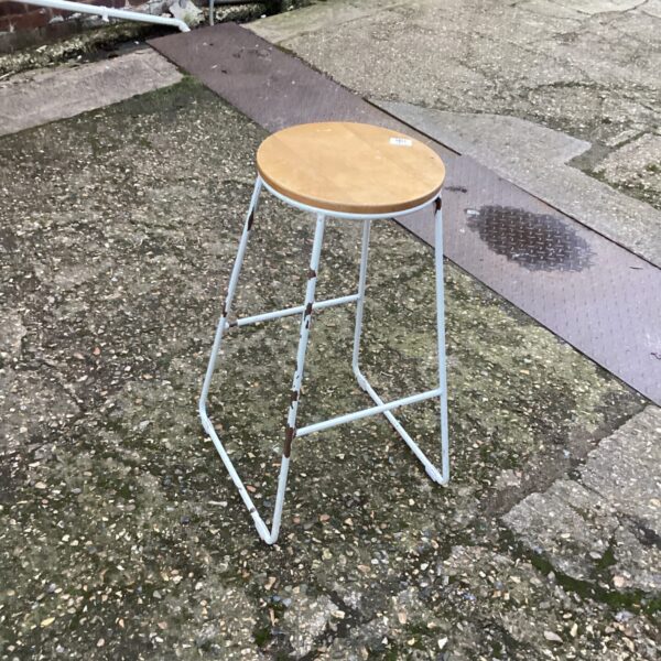 Vintage kitchen stool with wooden seat and metal frame.