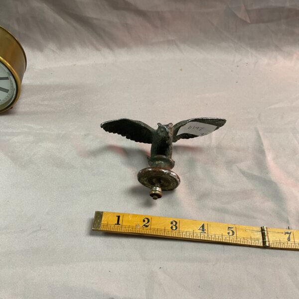 Vintage chrome owl car mascot, detailed automotive ornament.