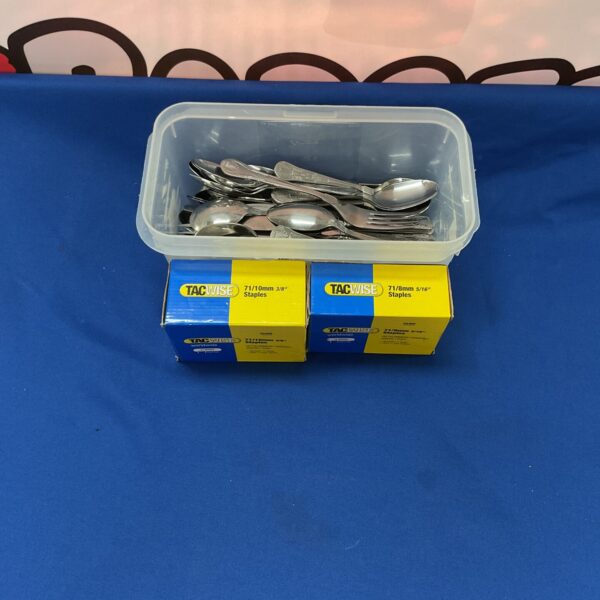 Mixed cutlery lot with stainless steel utensils and boxes of staples.
