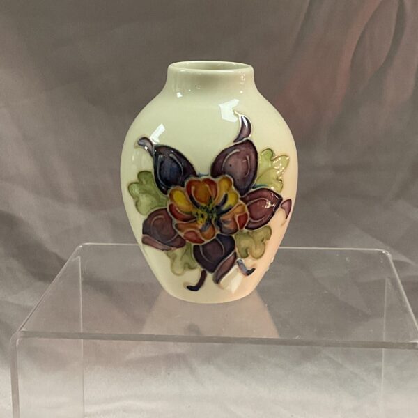 Small Moorcroft vase with vibrant floral design.