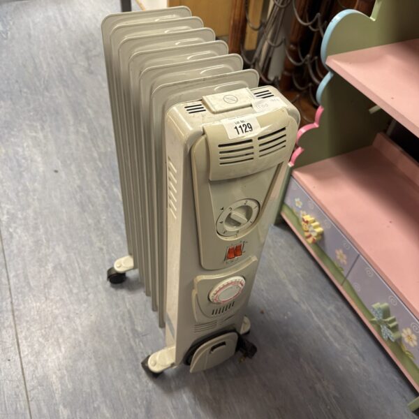 White oil filled radiator with adjustable heat settings.
