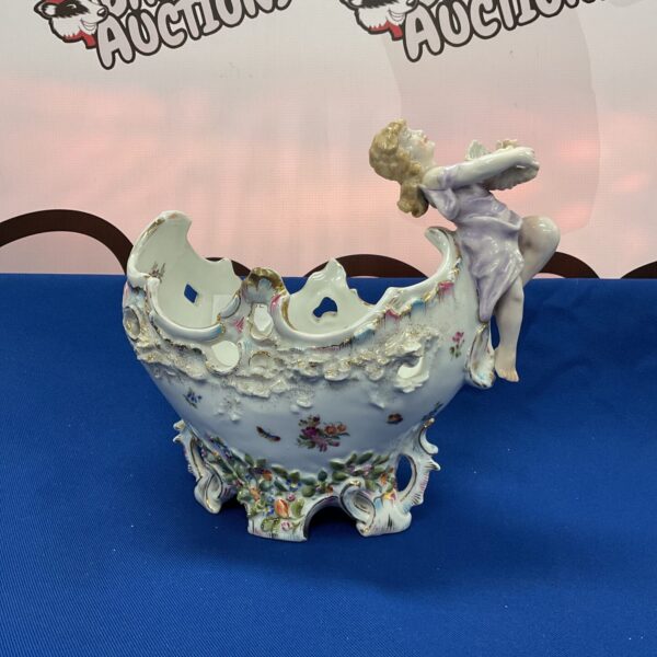 Antique Meissen style porcelain bowl with cherub detail.