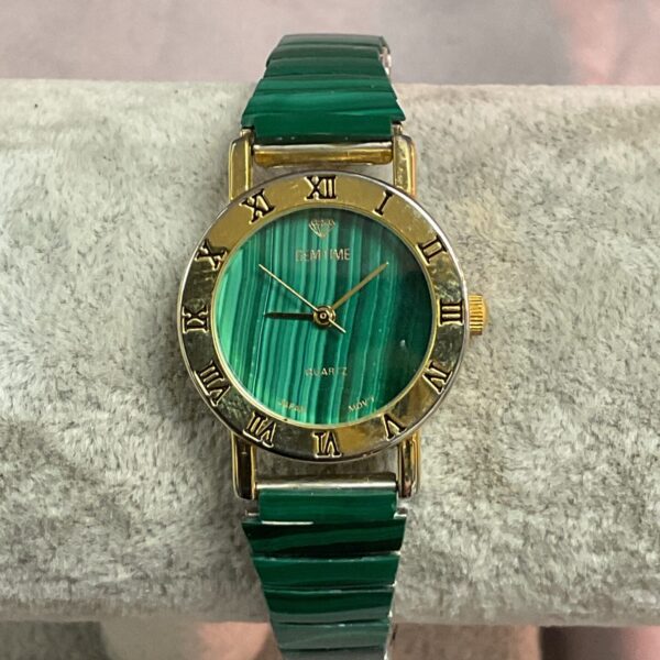 Vintage Gemtime quartz wristwatch with green dial and gold bracelet.