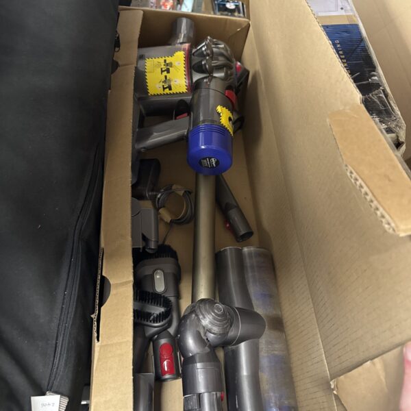 Dyson V8 cordless vacuum cleaner with charger and accessories.