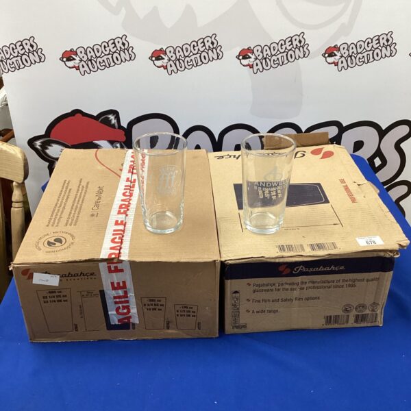 Two boxes of branded pint glasses from Triple FFF and Andwell breweries.