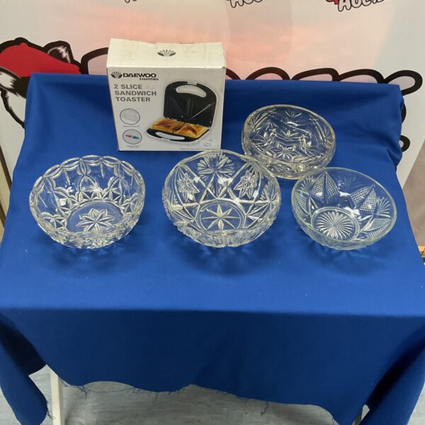 Crystal serving bowls and a Daewoo mini toaster set on a table.