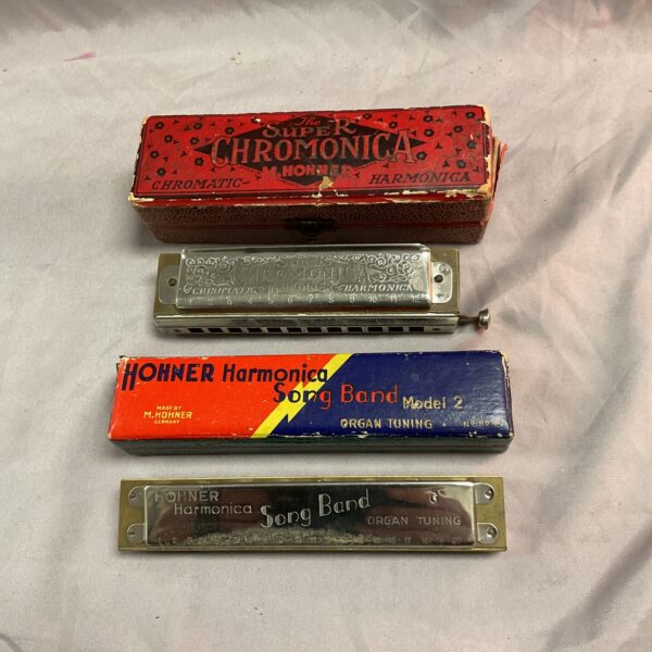 Vintage Hohner harmonica lot featuring Chromonica and Songbird instruments.