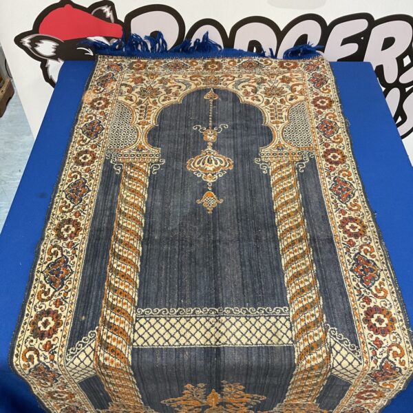 Vintage Islamic prayer mat with intricate geometric designs.