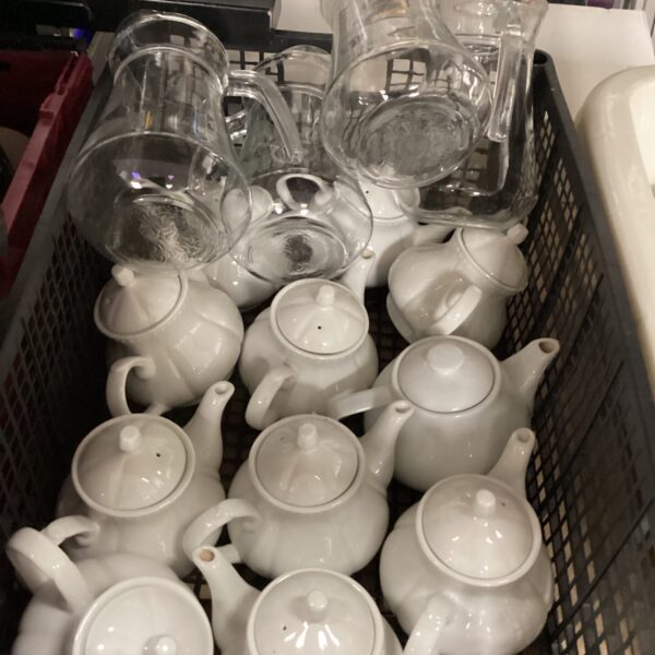 Vintage collection of ceramic tea pots and jugs on display.
