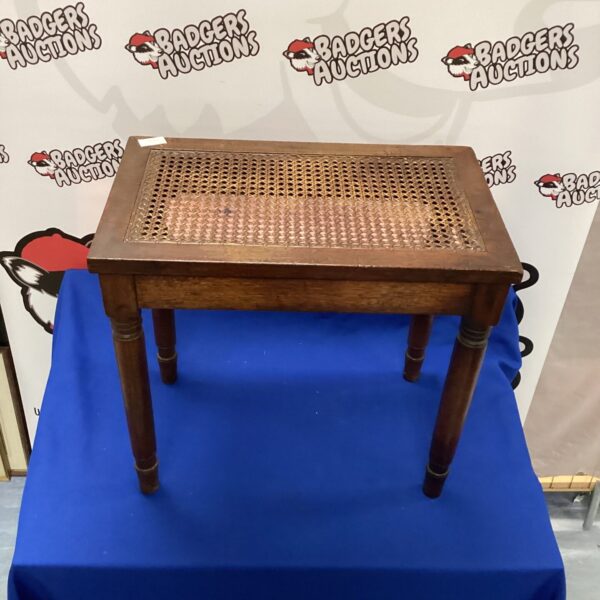 Vintage oak side table with cane inset and curved legs.