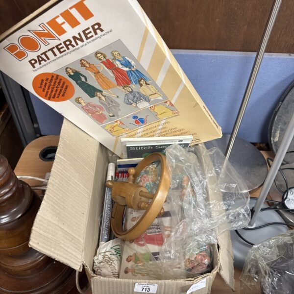 Vintage sewing and knitting box with various patterns and supplies.
