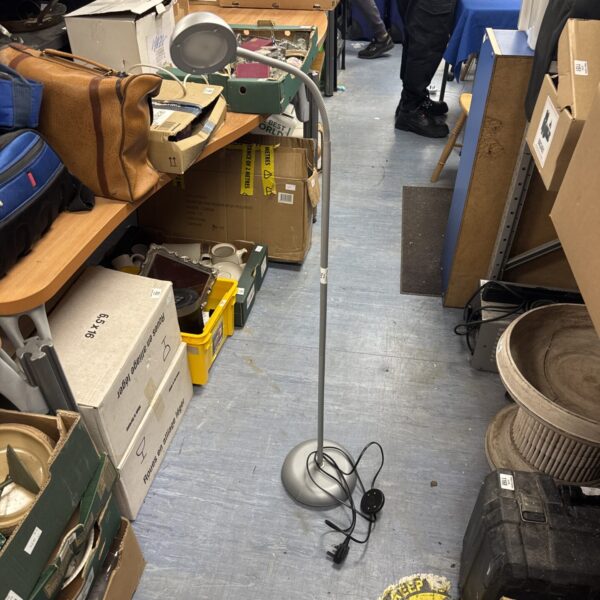 Vintage adjustable floor lamp with a crack in the base.