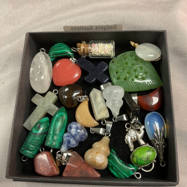 Tray of mixed crystal and stone pendants for jewellery making.
