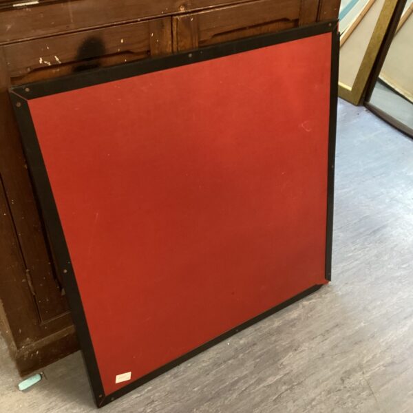 Vintage red folding card table for game nights.