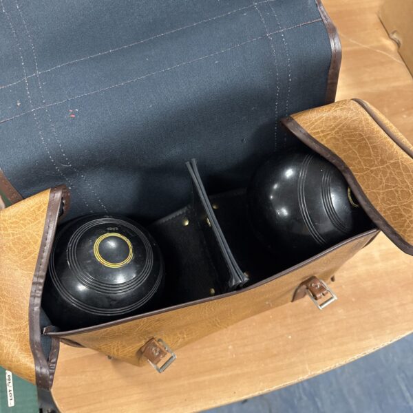 Vintage lawn bowls set in a carry case for outdoor games.