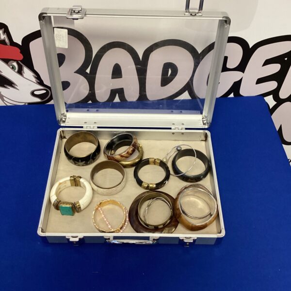 Vintage bangle collection in aluminium case, retro jewellery.