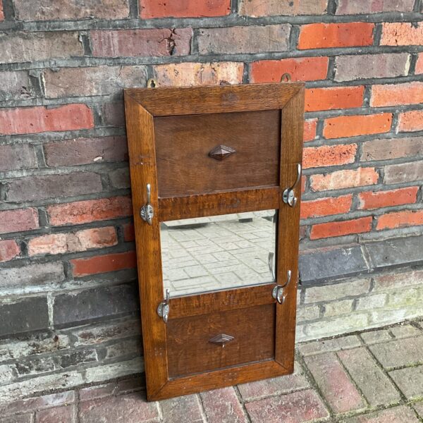 Vintage oak coat rack with mirror and coat hooks.