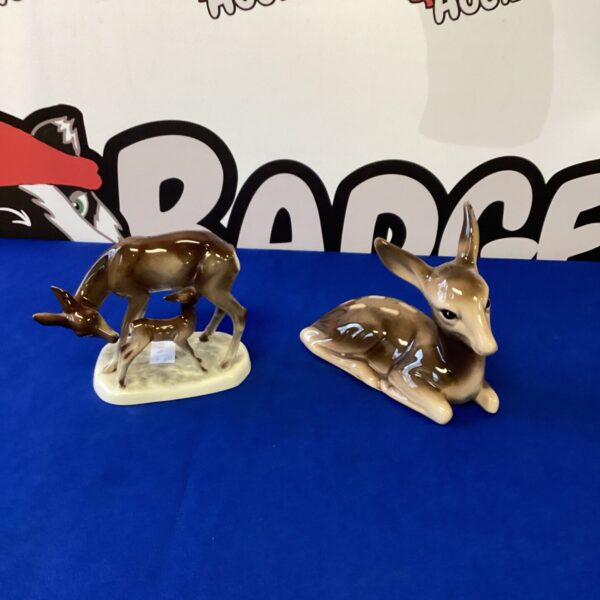 Pair of vintage porcelain deer figurines on display.