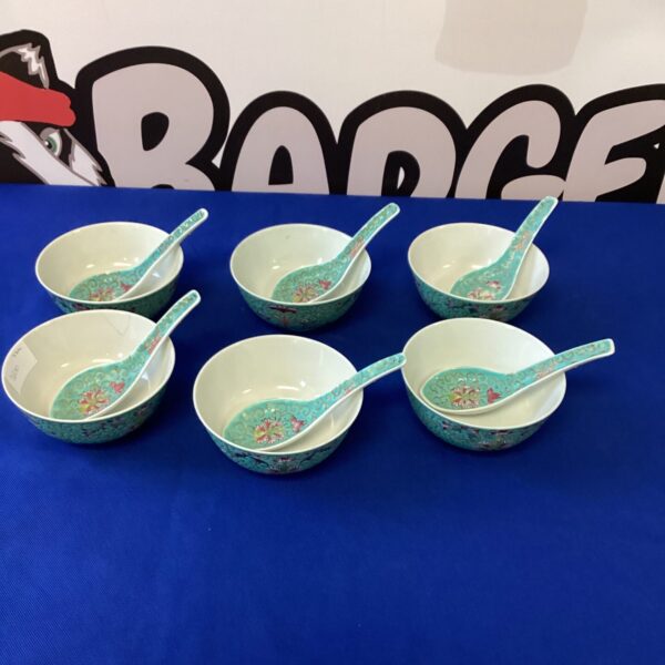 Six Japanese soup bowls with spoons featuring a floral design.