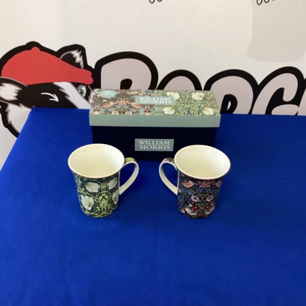 Two William Morris china mugs with a colourful floral pattern.